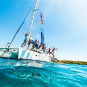 the Yacht Week Greece catamaran with people jumping off