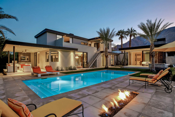 palm springs villa rental pool at night with firepit