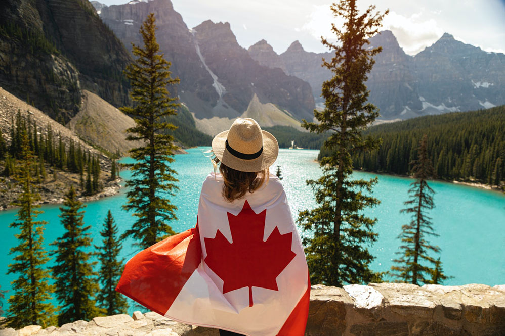 best canada travel destinations girl with canadian flag