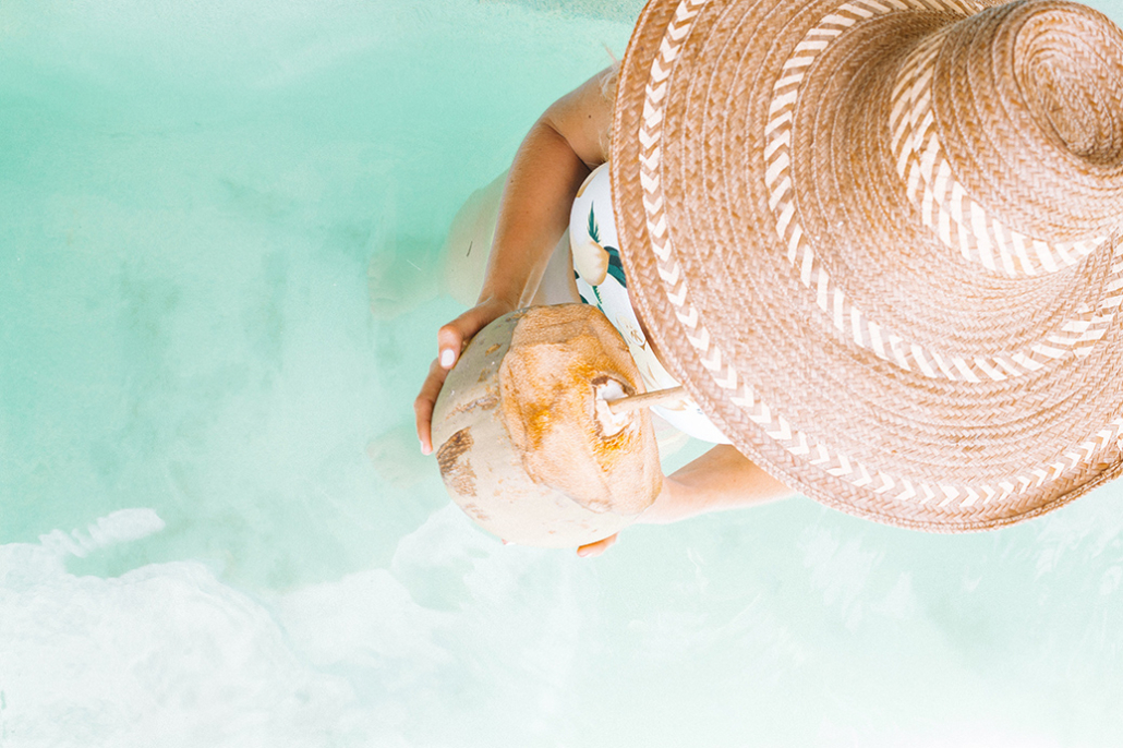 top luxury hotels & resorts for an aruba travel getaway drinking coconut