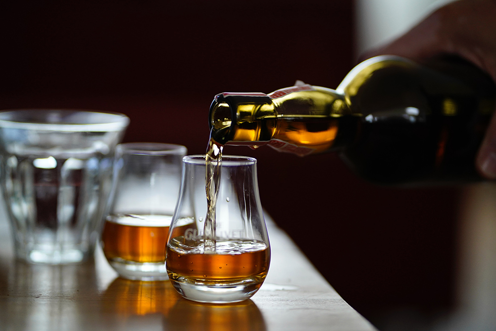 pouring whisky in scotland